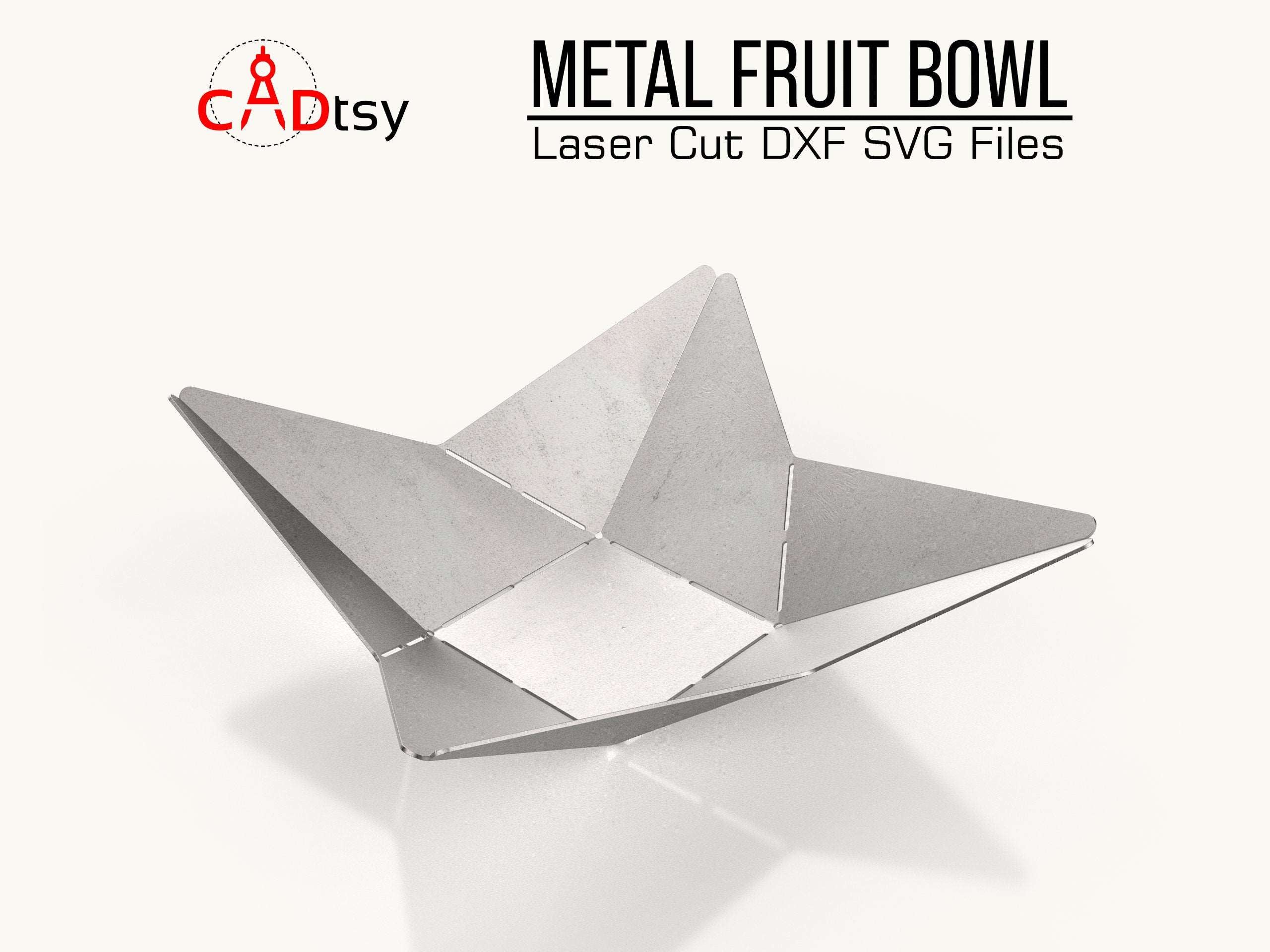 An artistic metal origami fruit bowl, made from plasma dxf files, shown as a centerpiece on a modern table.